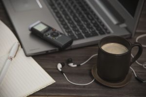 Journalist's,work,at,a,computer,with,a,voice,recorder